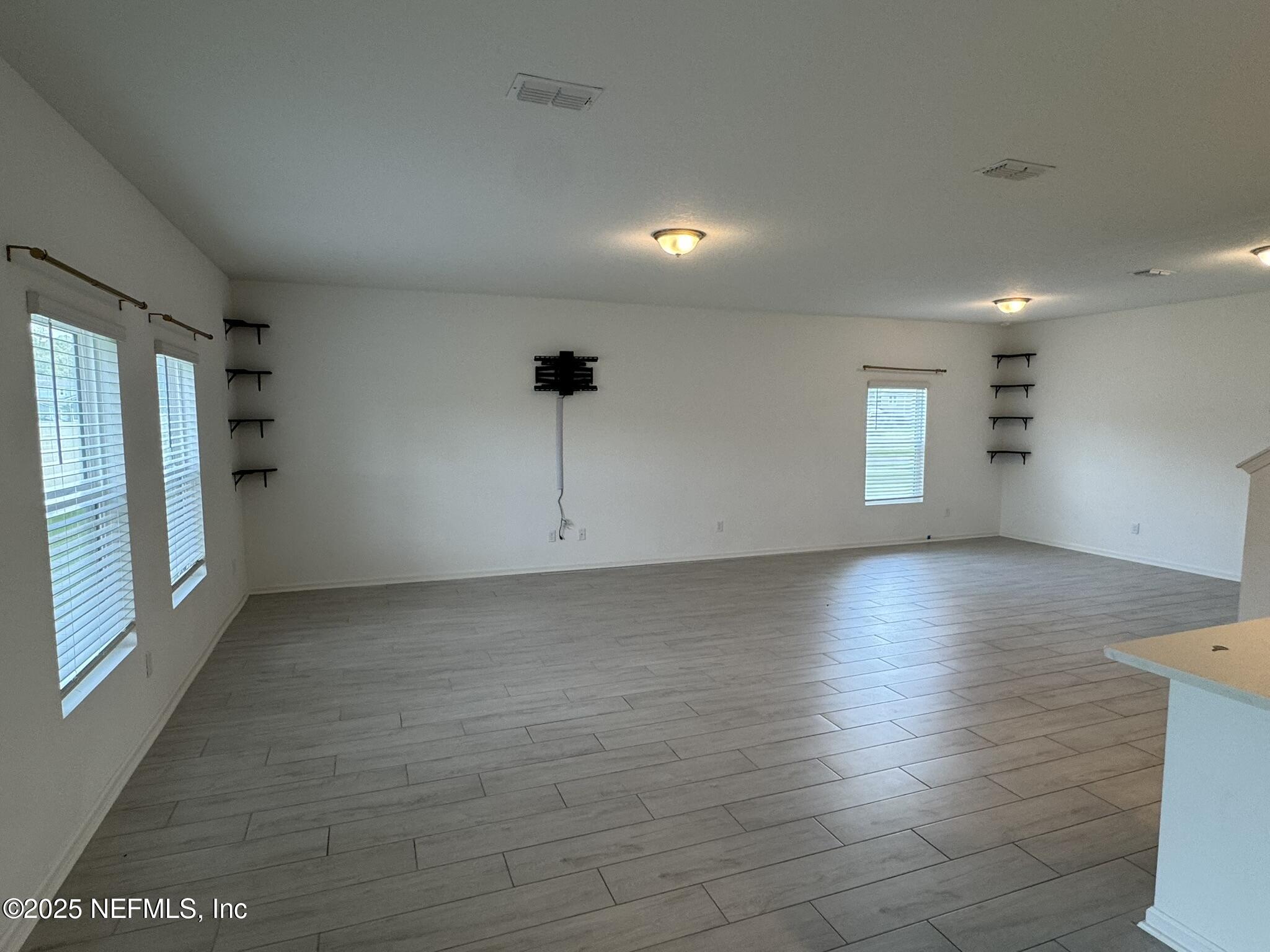 3145 Flower Branch Avenue Orange Park, FL 32073 - Photo 18 of 52 wooden floor in an empty room with a window