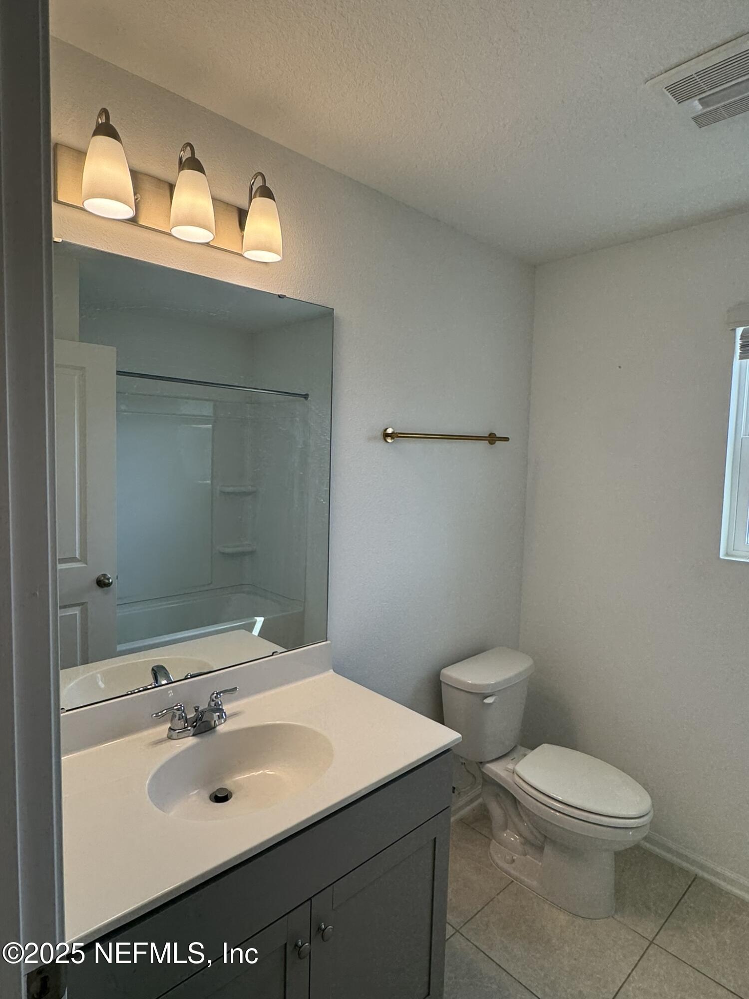3145 Flower Branch Avenue Orange Park, FL 32073 - Photo 27 of 52 a bathroom with a sink a toilet and mirror