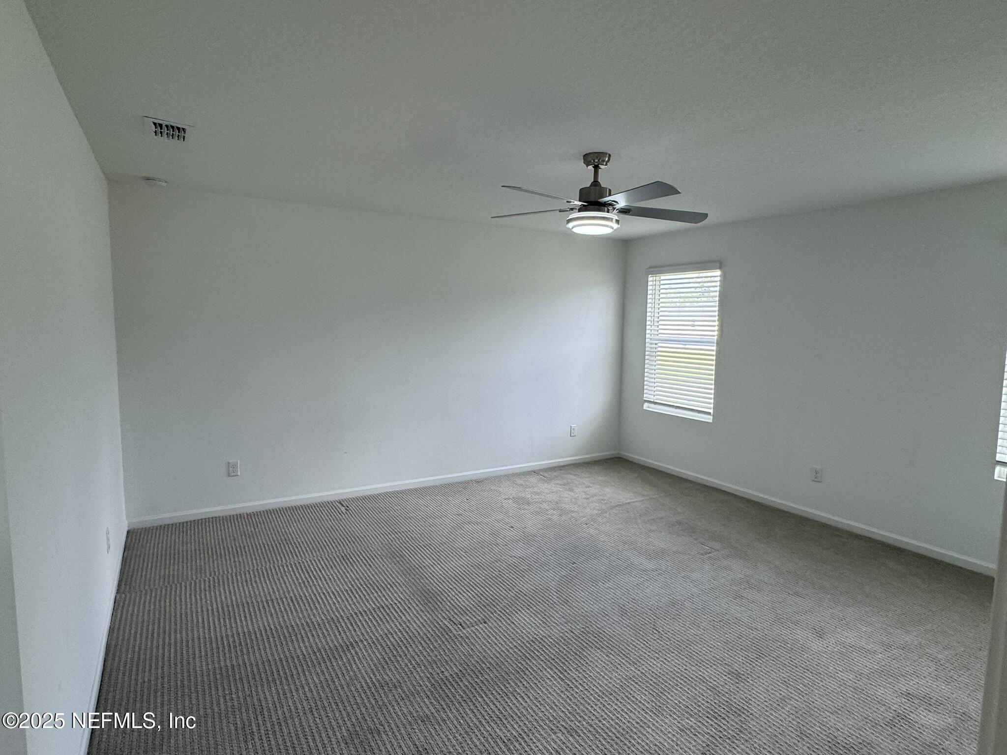 3145 Flower Branch Avenue Orange Park, FL 32073 - Photo 40 of 52 an empty room with windows and chandelier fan