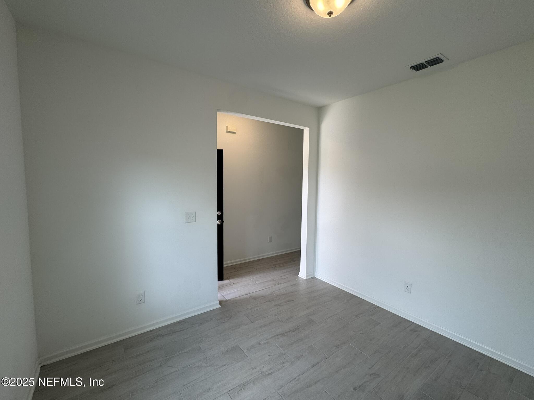 3145 Flower Branch Avenue Orange Park, FL 32073 - Photo 9 of 52 a view of an empty room with wooden floor