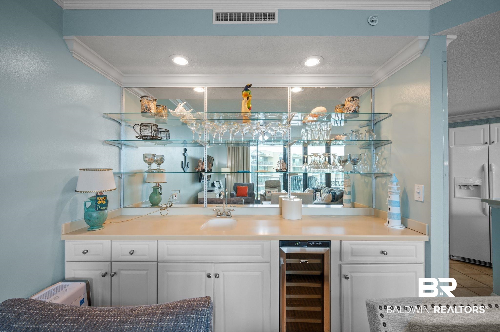 27580 Canal Road, Unit 1427 Orange Beach, AL 36561 - Photo 16 of 38 Indoor wet bar featuring wine cooler, open shelves, white fridge with ice dispenser, white cabinetry, and crown molding