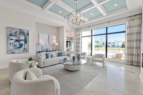 a view of a dining room with furniture a chandelier and wooden floor