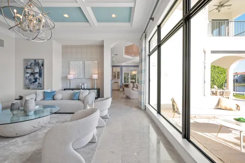 a living room with furniture a rug and a ceiling fan