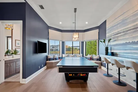 a spacious bedroom with a bed and a chandelier