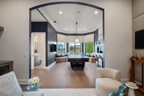 a view of a patio with a dining table and chairs with a floor to ceiling window