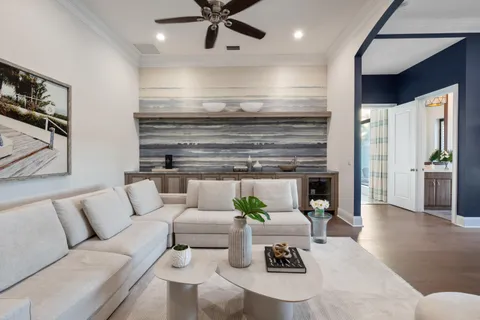 a living room with patio furniture and a large window