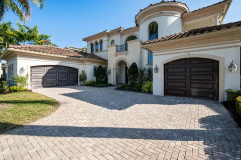 a living room with furniture a chandelier and a flat screen tv