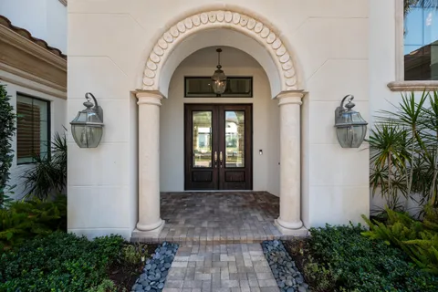 a living room with furniture a ceiling fan and a large window