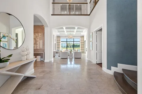 a large kitchen with kitchen island a large window a sink and cabinets