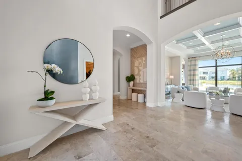 a view of a dining room with furniture and a chandelier
