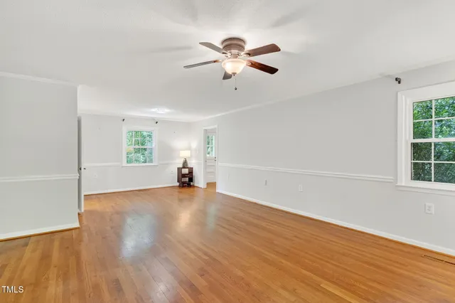 a view of empty room with wooden floor