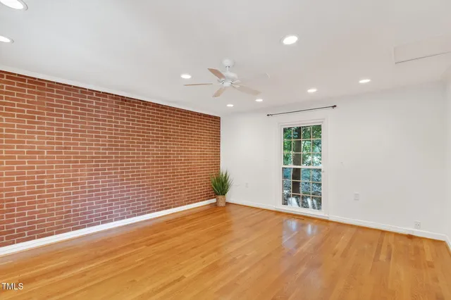 a living room with furniture a rug and a bookshelf