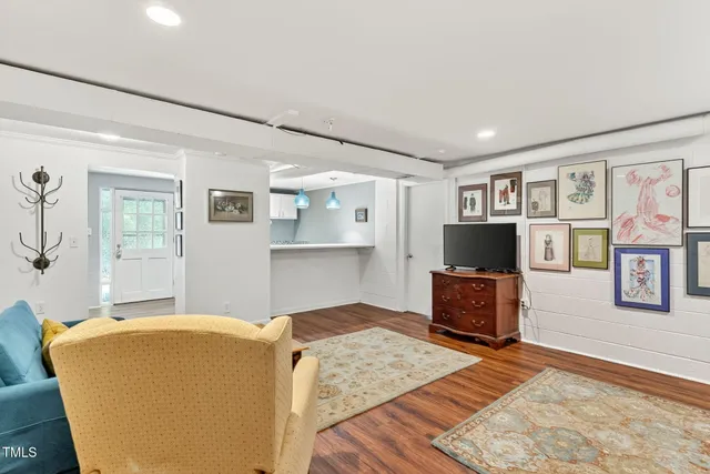 a living room with furniture and wooden floor