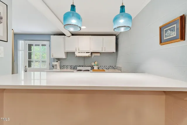 a view of kitchen with wooden floor and electronic appliances