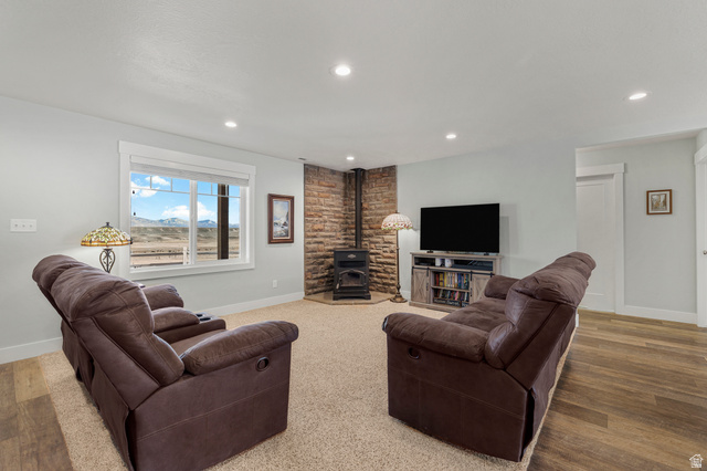 18573 South Marsh Valley Road Downey, ID 83234 - Photo 5 of 32 Living area with a wood stove, wood finished floors, and recessed lighting