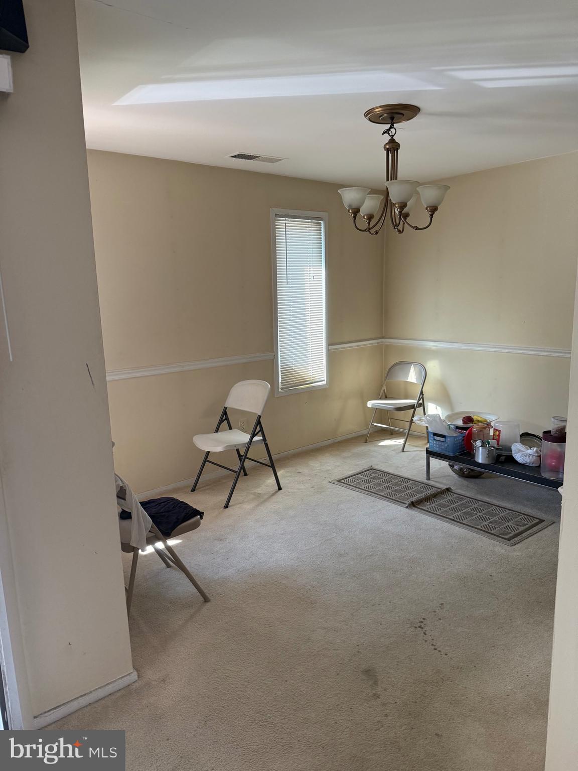 531 Florida Avenue, Unit 104 Herndon, VA 20170 - Photo 18 of 46 a living room with furniture and a chandelier