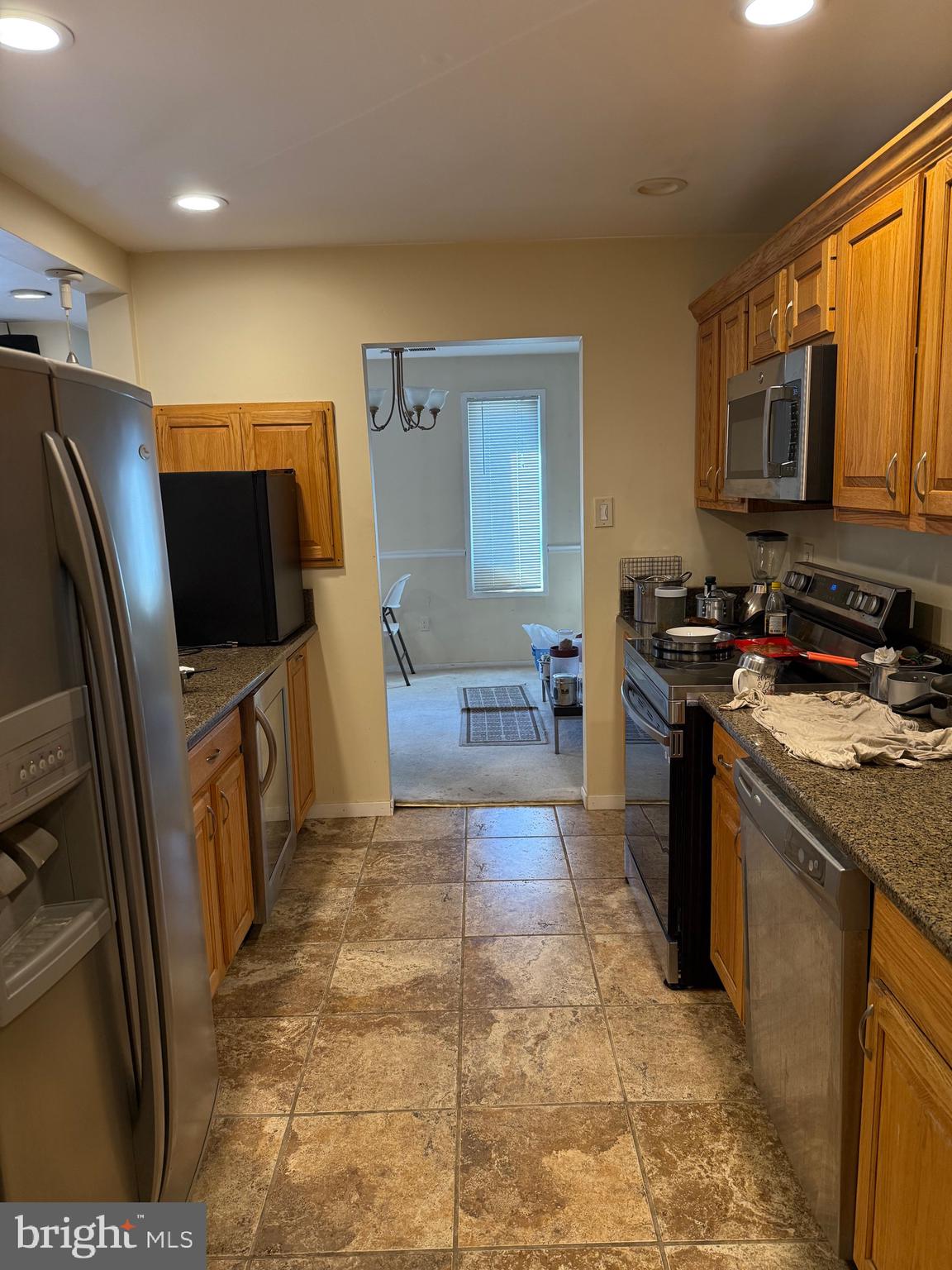 531 Florida Avenue, Unit 104 Herndon, VA 20170 - Photo 22 of 46 a kitchen with stainless steel appliances granite countertop a stove a sink and a microwave