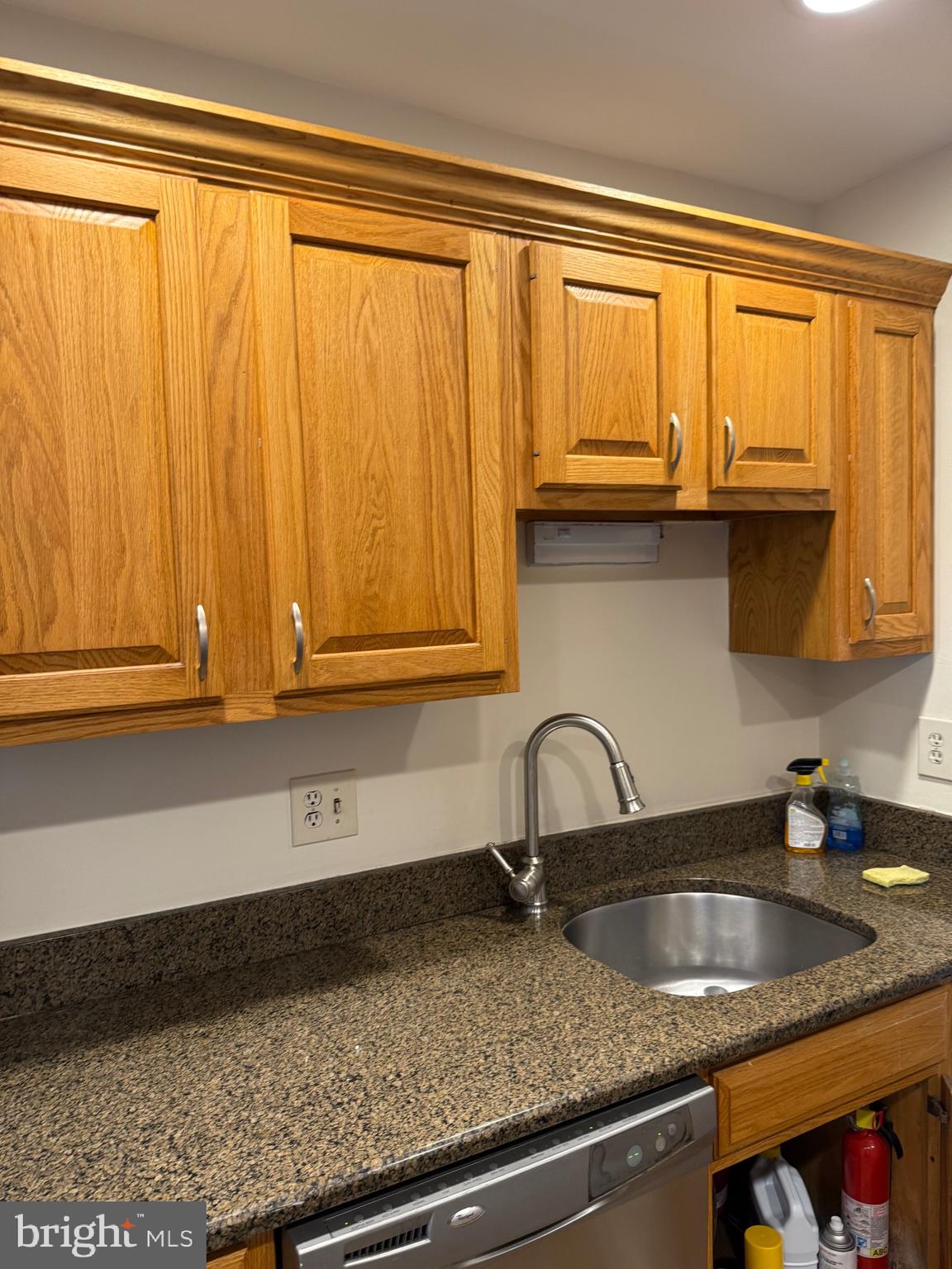 531 Florida Avenue, Unit 104 Herndon, VA 20170 - Photo 4 of 46 a kitchen with granite countertop a sink and cabinets