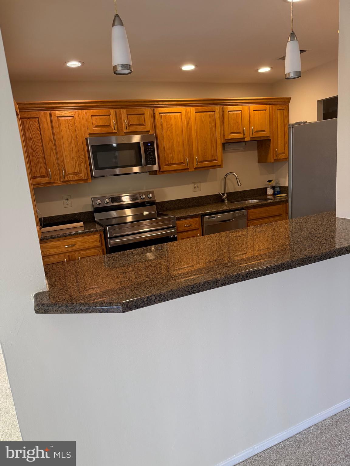 531 Florida Avenue, Unit 104 Herndon, VA 20170 - Photo 41 of 46 a view of kitchen with stainless steel appliances granite countertop refrigerator sink and stove
