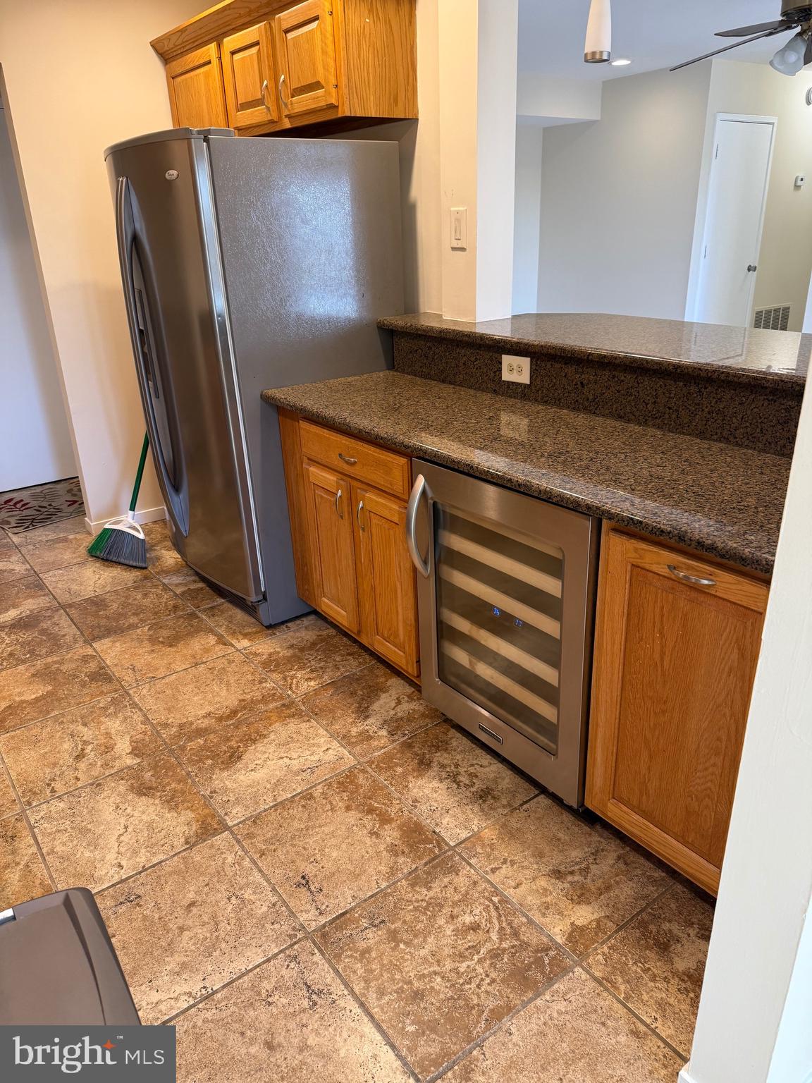 531 Florida Avenue, Unit 104 Herndon, VA 20170 - Photo 5 of 46 a view of a refrigerator with wooden cabinets