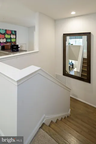 a room with a wooden floor and a mirror
