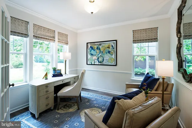 a view of a livingroom with workspace and a window