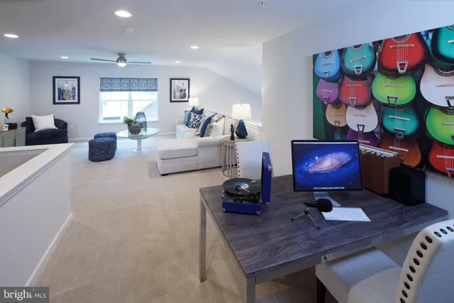 a living room with furniture and wall paintings