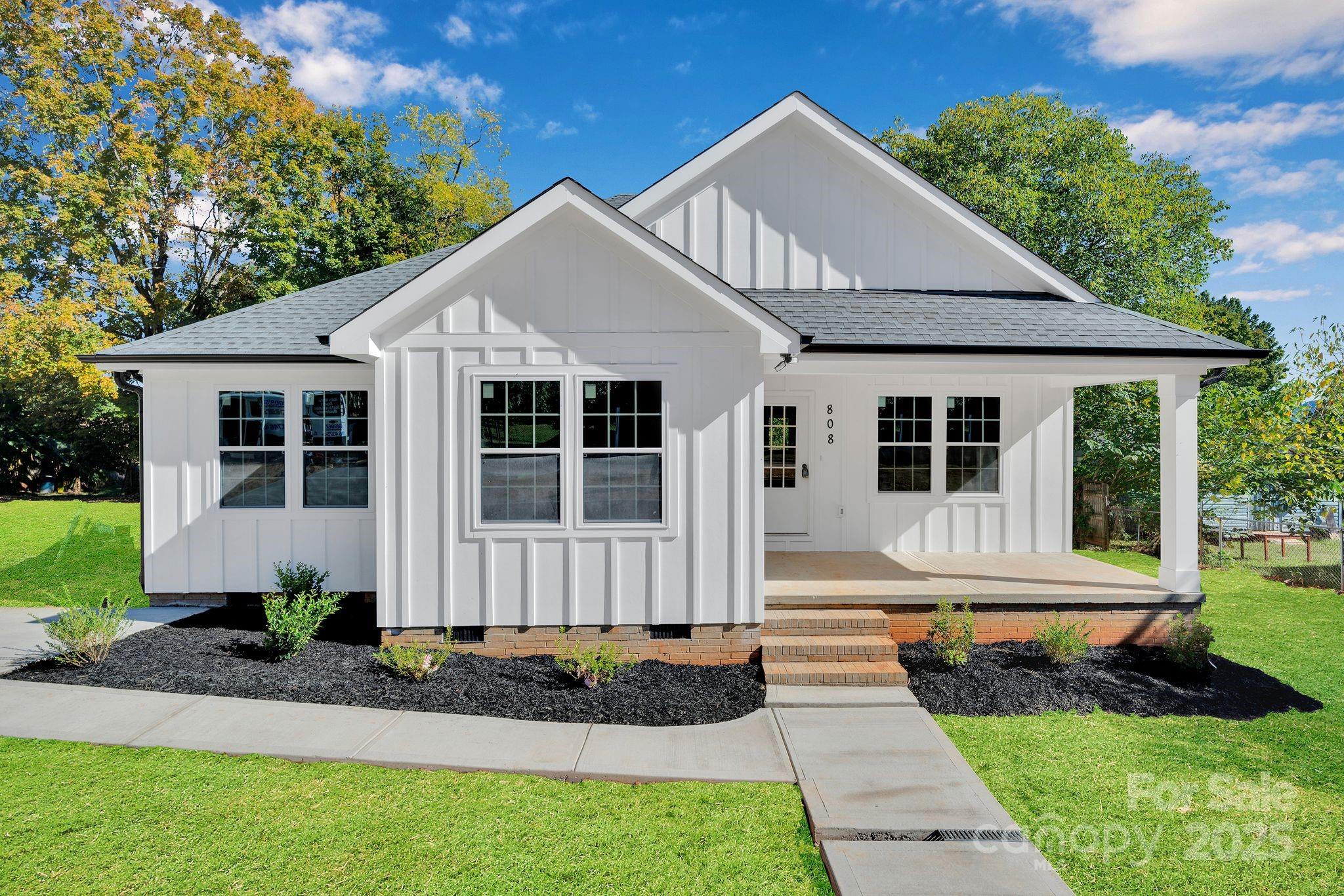 a front view of a house with a yard and porch