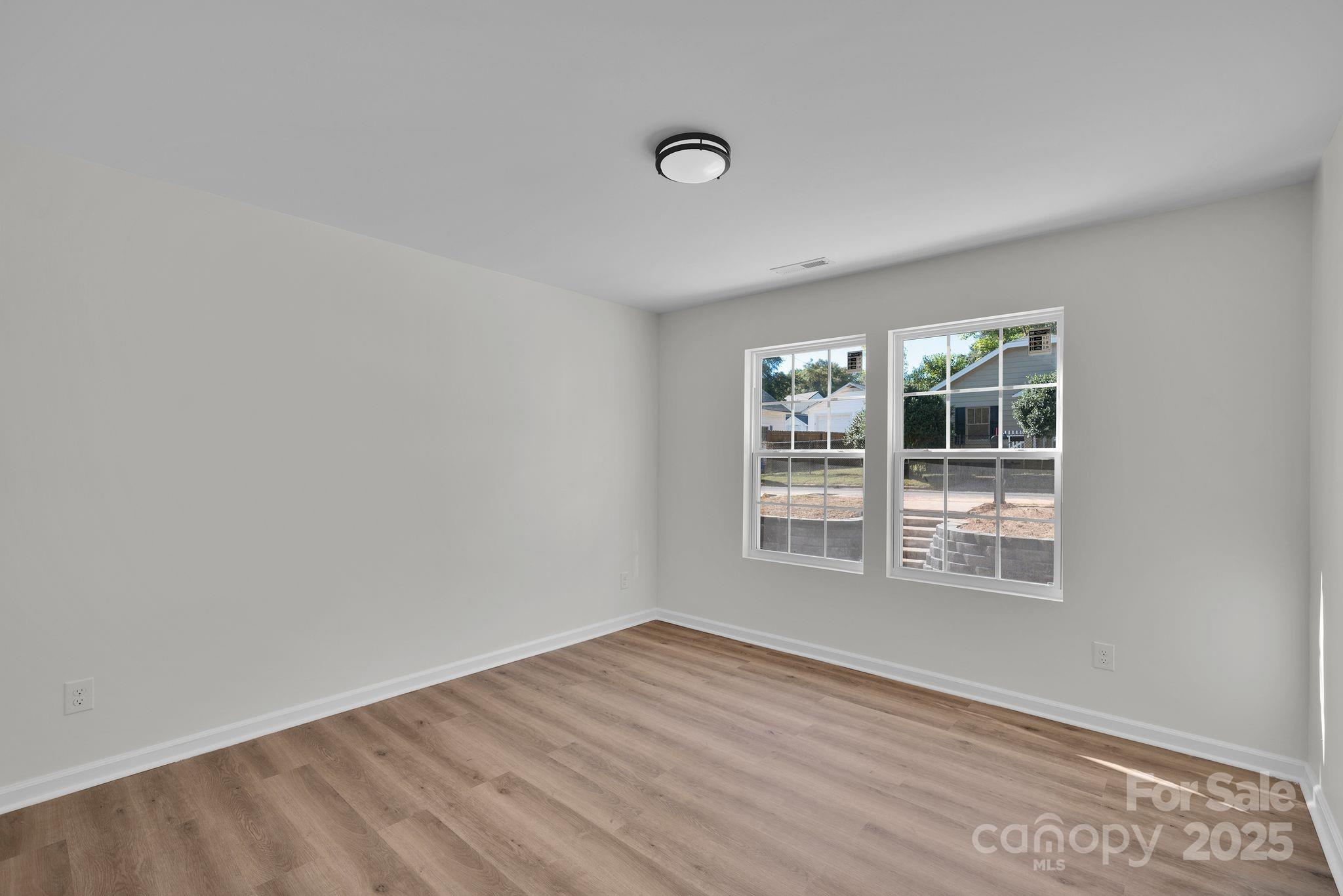 808 3rd Street Kings Mountain, NC 28086 - Photo 21 of 30 a view of an empty room with wooden floor and a window