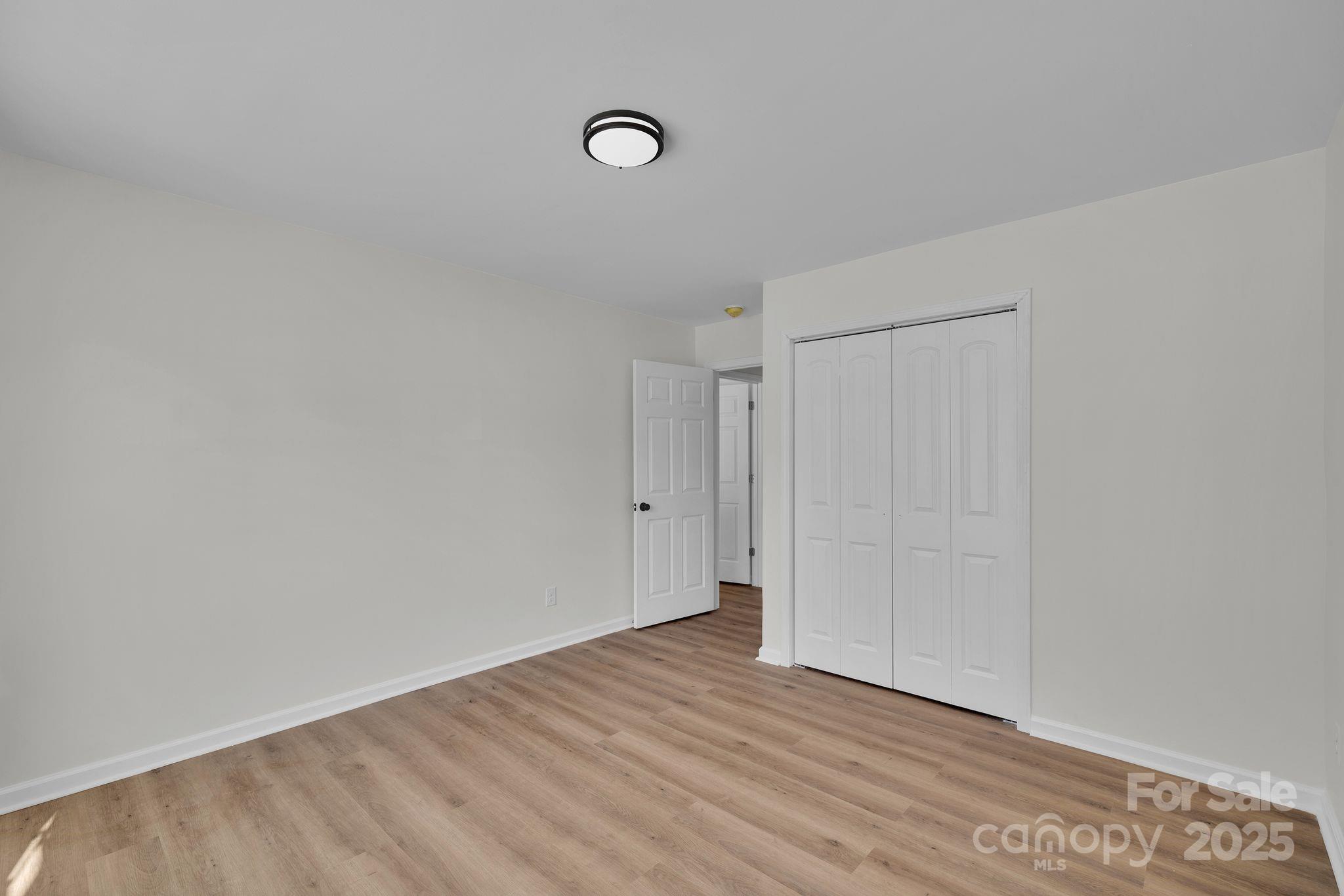 808 3rd Street Kings Mountain, NC 28086 - Photo 22 of 30 a view of an empty room with wooden floor