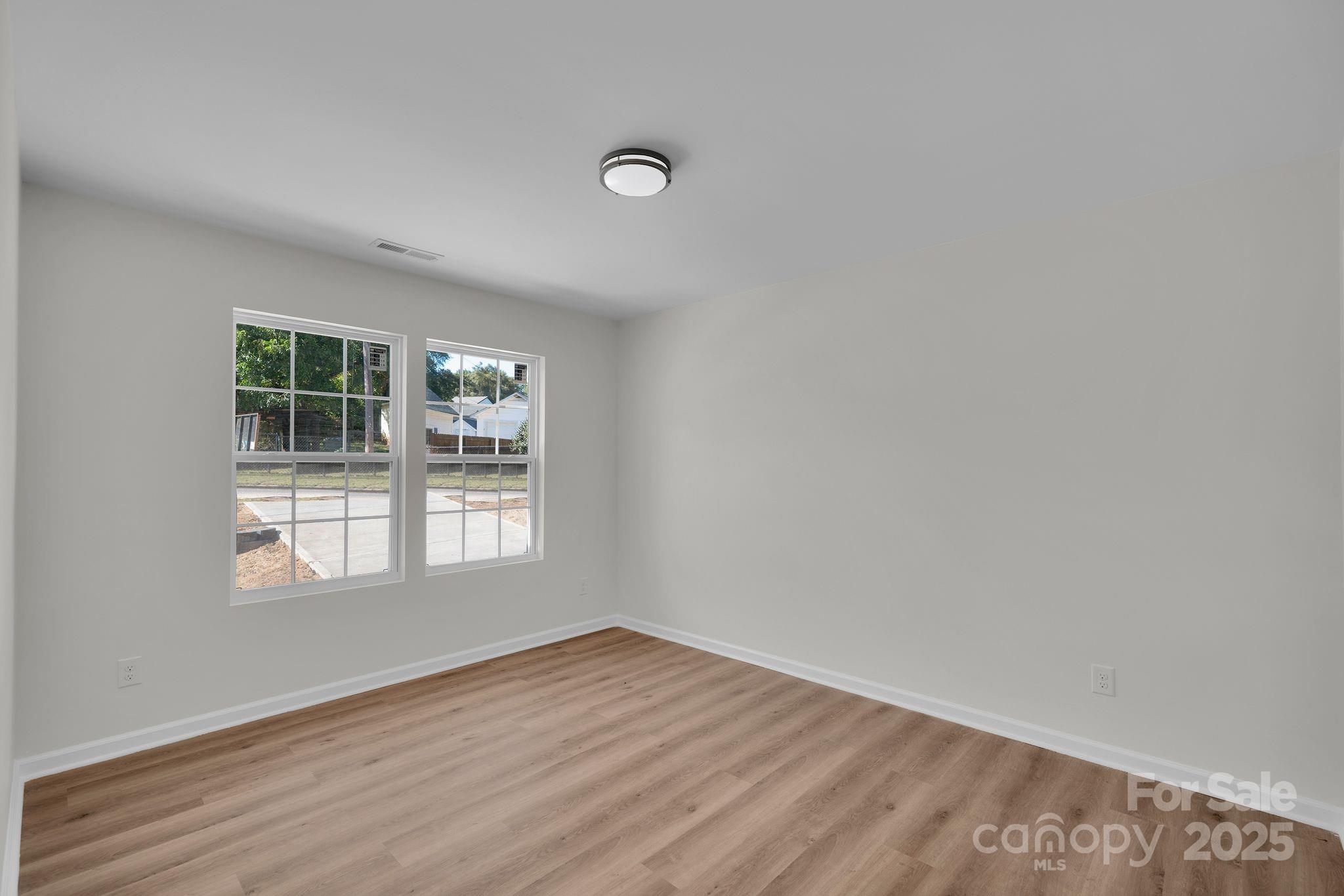 808 3rd Street Kings Mountain, NC 28086 - Photo 23 of 30 an empty room with wooden floor and windows