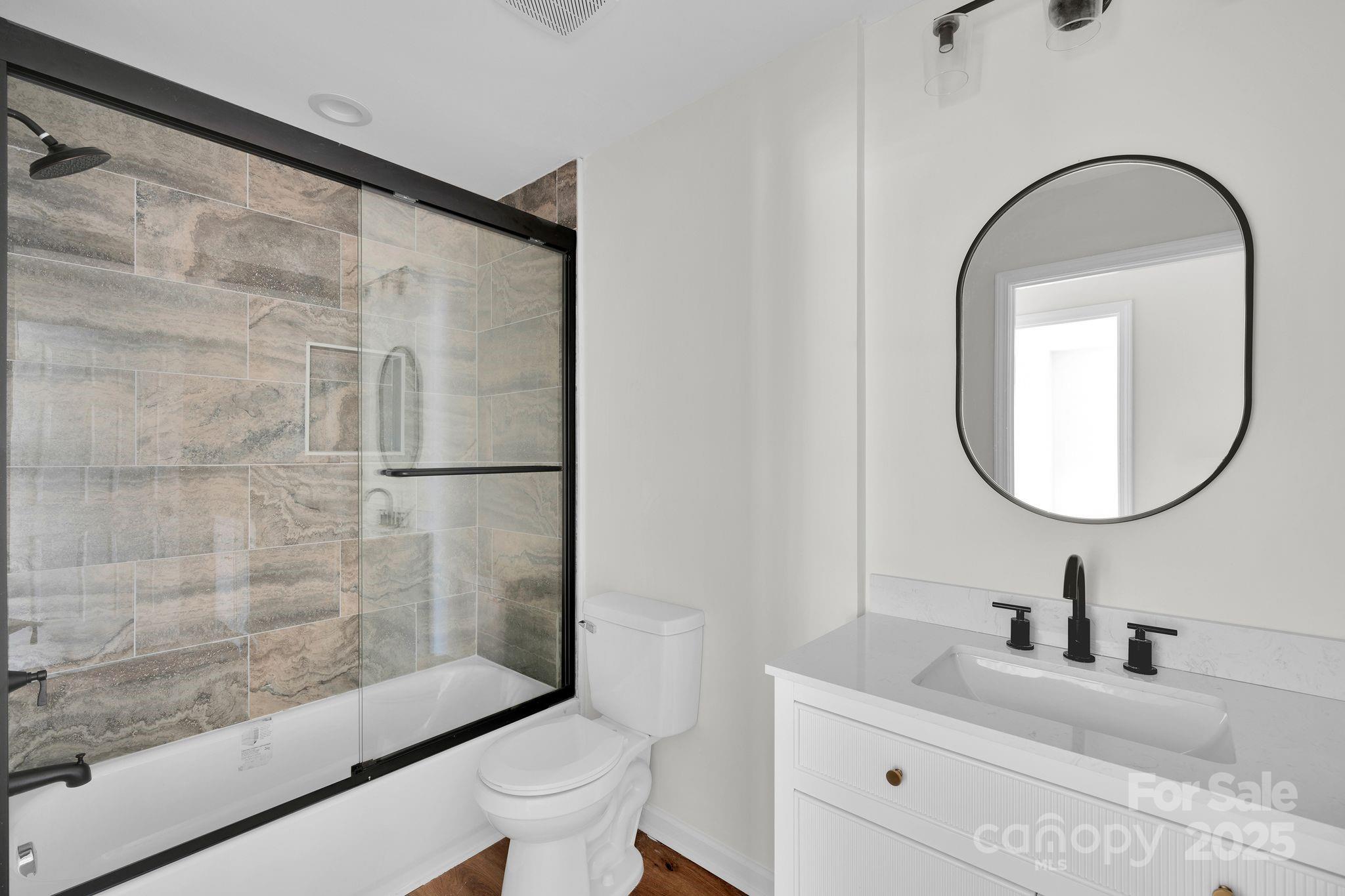 808 3rd Street Kings Mountain, NC 28086 - Photo 25 of 30 a bathroom with a granite countertop sink a toilet and a mirror