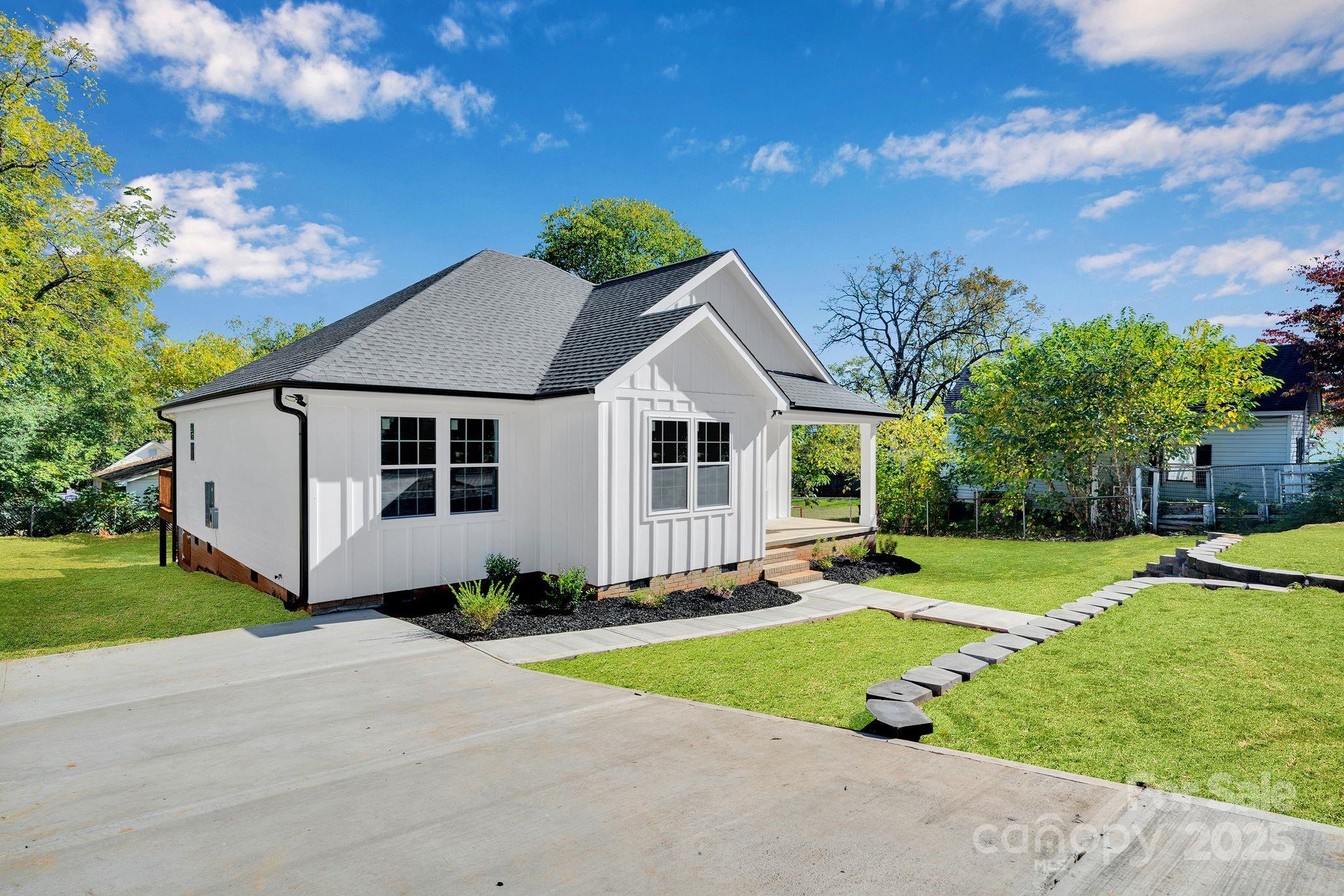 808 3rd Street Kings Mountain, NC 28086 - Photo 3 of 30 a front view of a house with a yard and garage