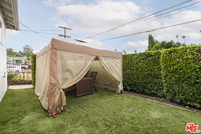 a view of a backyard with wooden fence
