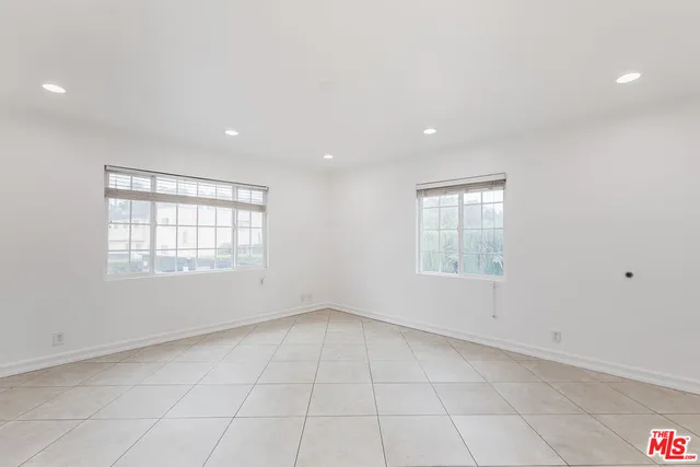 an empty room with windows and entrance