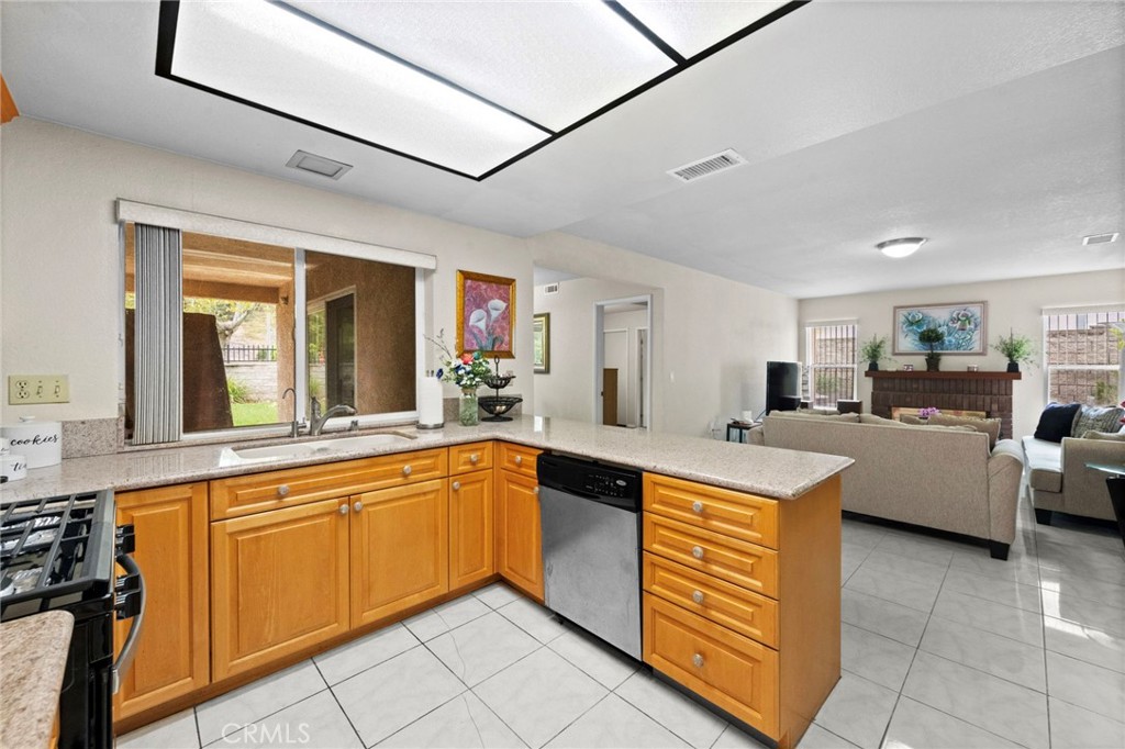 605 Bronco Way Walnut, CA 91789 - Photo 14 of 69 a large kitchen with a large counter top space a sink stainless steel appliances and cabinets