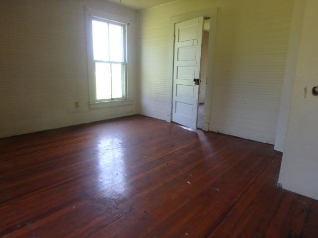 1025 Carroll Road Goodview, VA 24095 - Photo 4 of 6 an empty room with wooden floor and windows