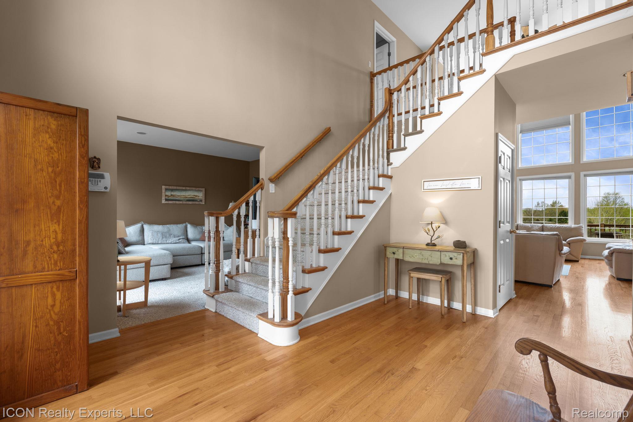 5128 Baldwin Road Metamora, MI 48455 - Photo 12 of 68 Staircase featuring a high ceiling and wood finished floors