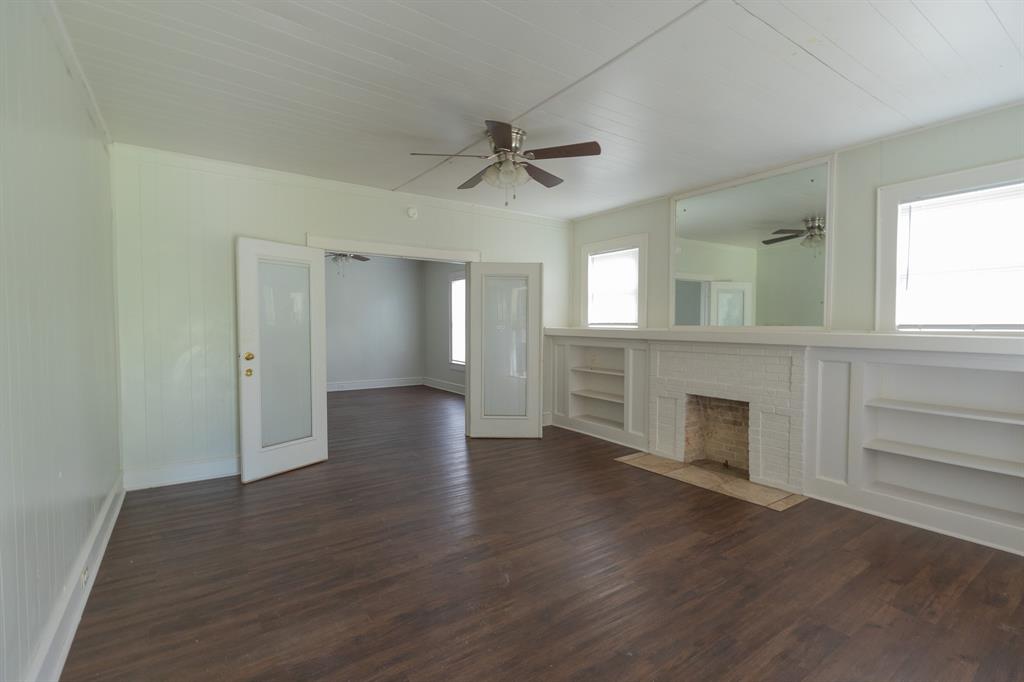 2913 Homan Avenue, Unit 2913 Waco, TX 76707 - Photo 2 of 16 Spacious room featuring dark wood-finish flooring, a white paneled ceiling, and light-colored walls