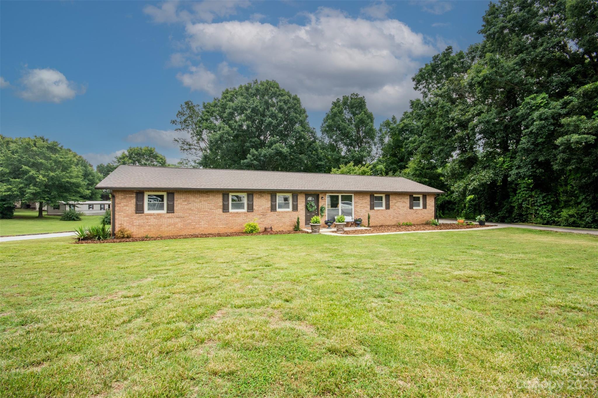 357 Pop Davis Road Taylorsville, NC 28681 - Photo 1 of 45 a front view of a house with a garden
