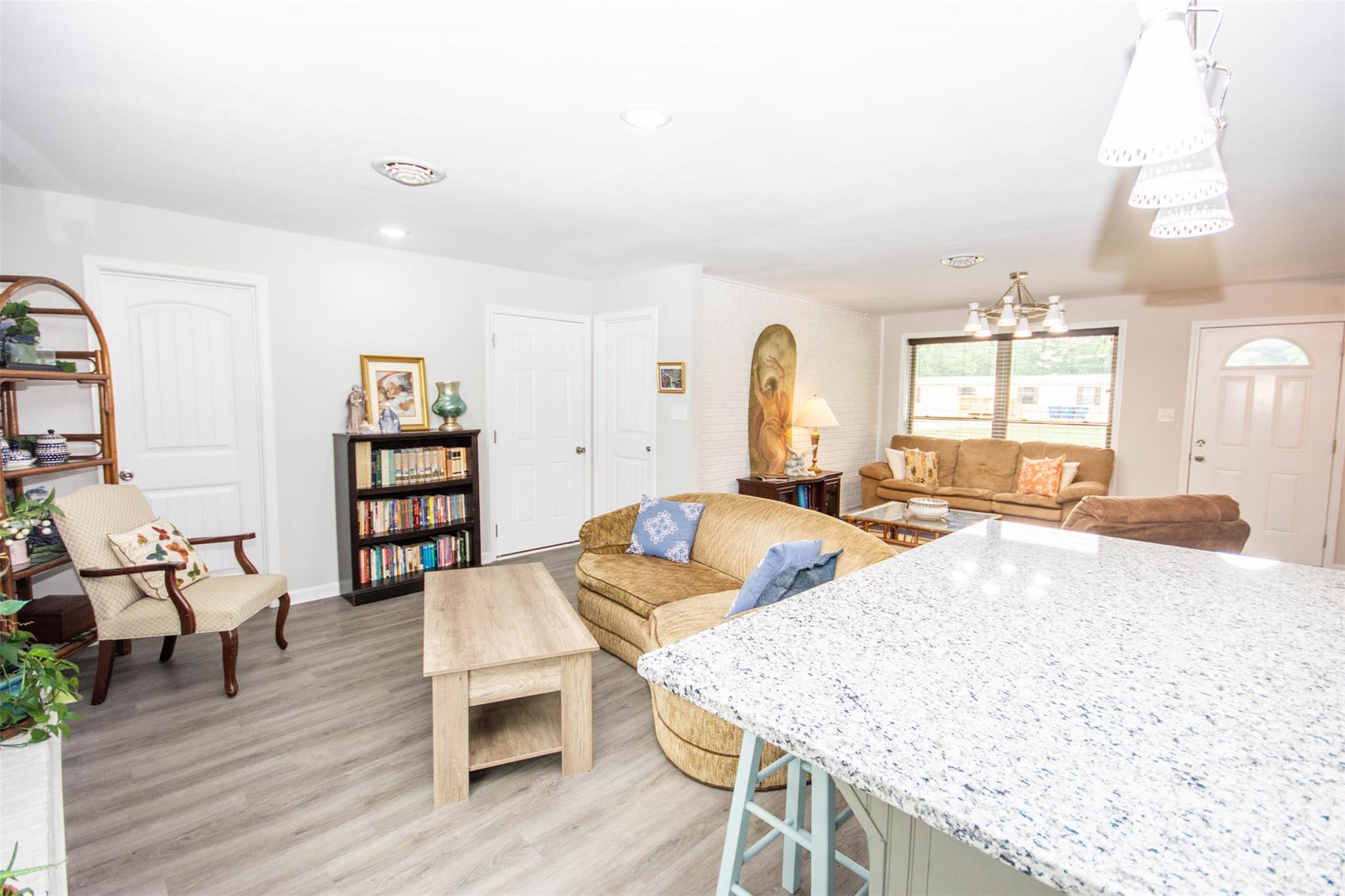 357 Pop Davis Road Taylorsville, NC 28681 - Photo 13 of 45 a living room with furniture a wooden floor and next to a window