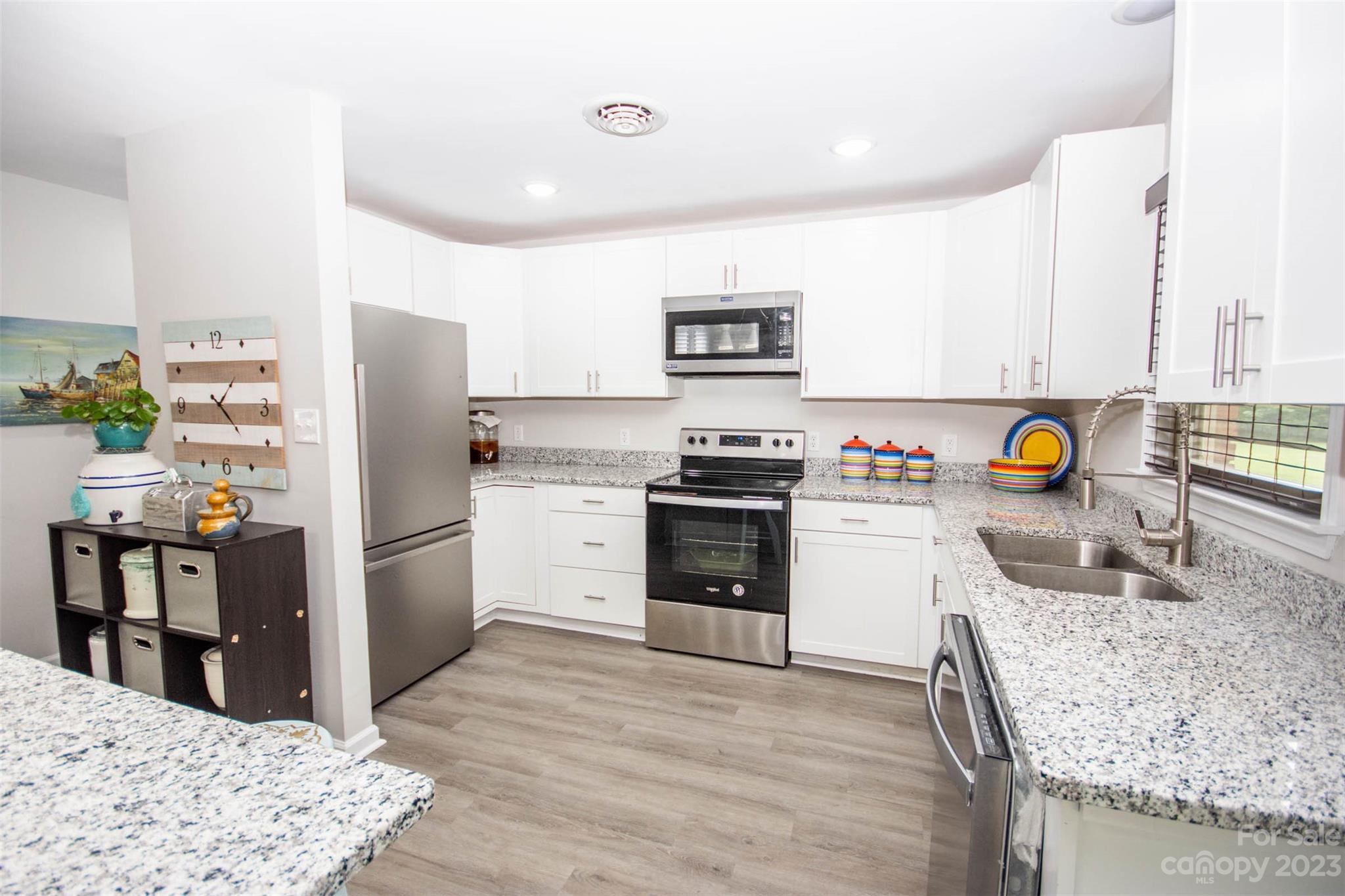 357 Pop Davis Road Taylorsville, NC 28681 - Photo 17 of 45 a kitchen with a stove a refrigerator and a sink