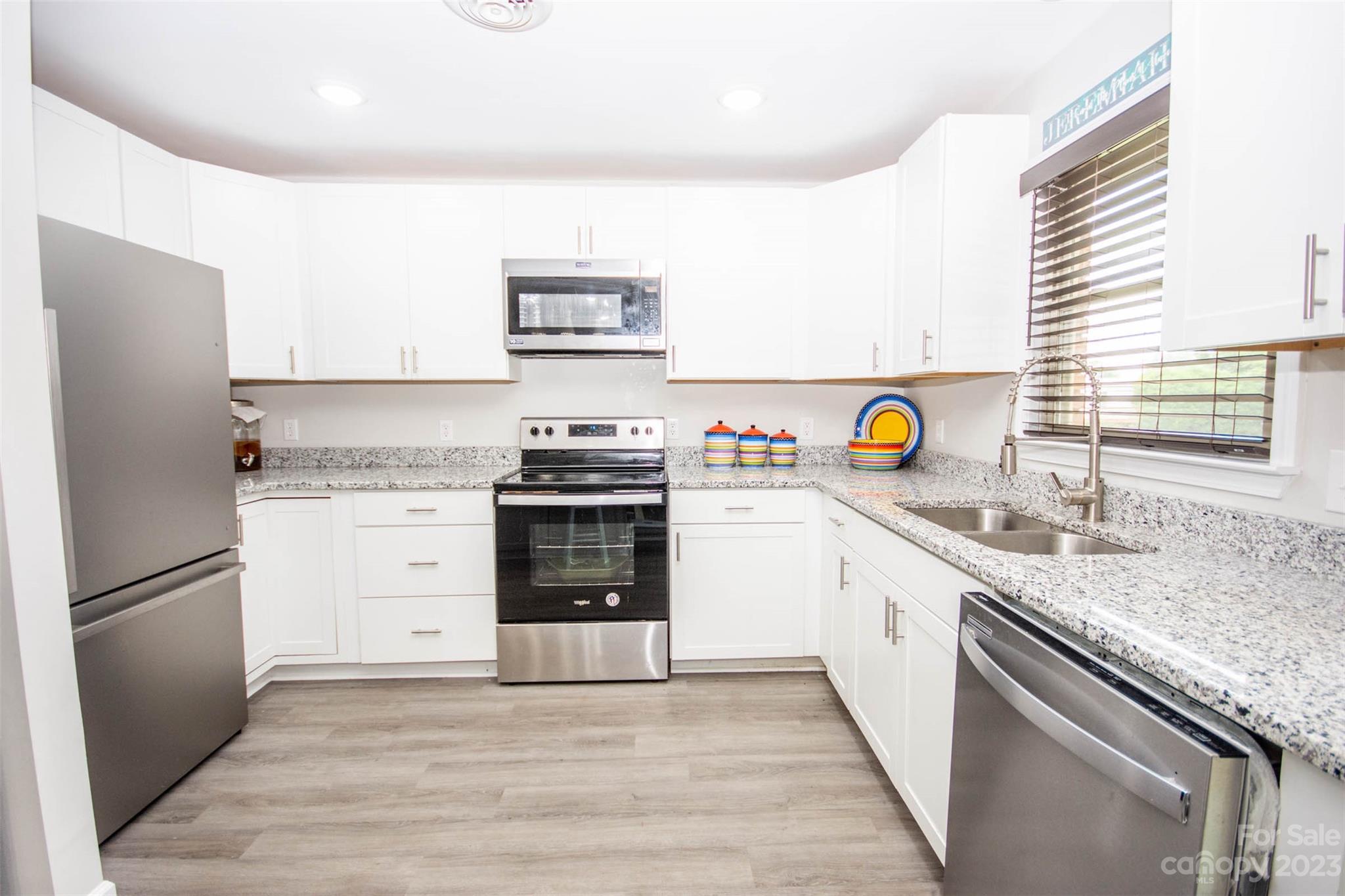 357 Pop Davis Road Taylorsville, NC 28681 - Photo 18 of 45 a kitchen with stainless steel appliances granite countertop a refrigerator sink and stove