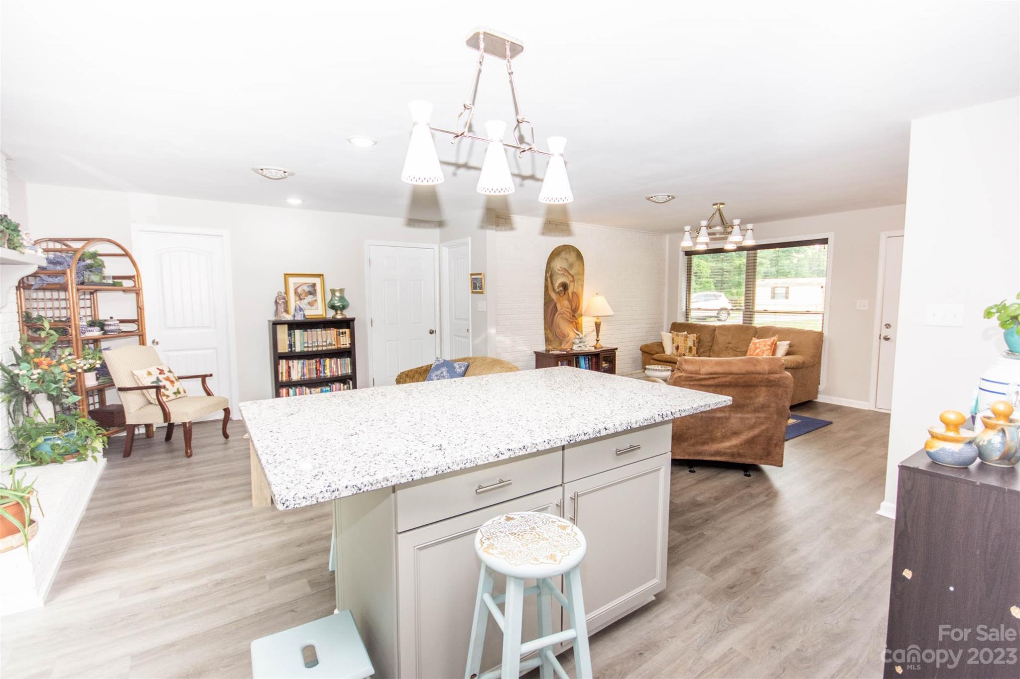 357 Pop Davis Road Taylorsville, NC 28681 - Photo 19 of 45 a living room with dining table and wooden floor
