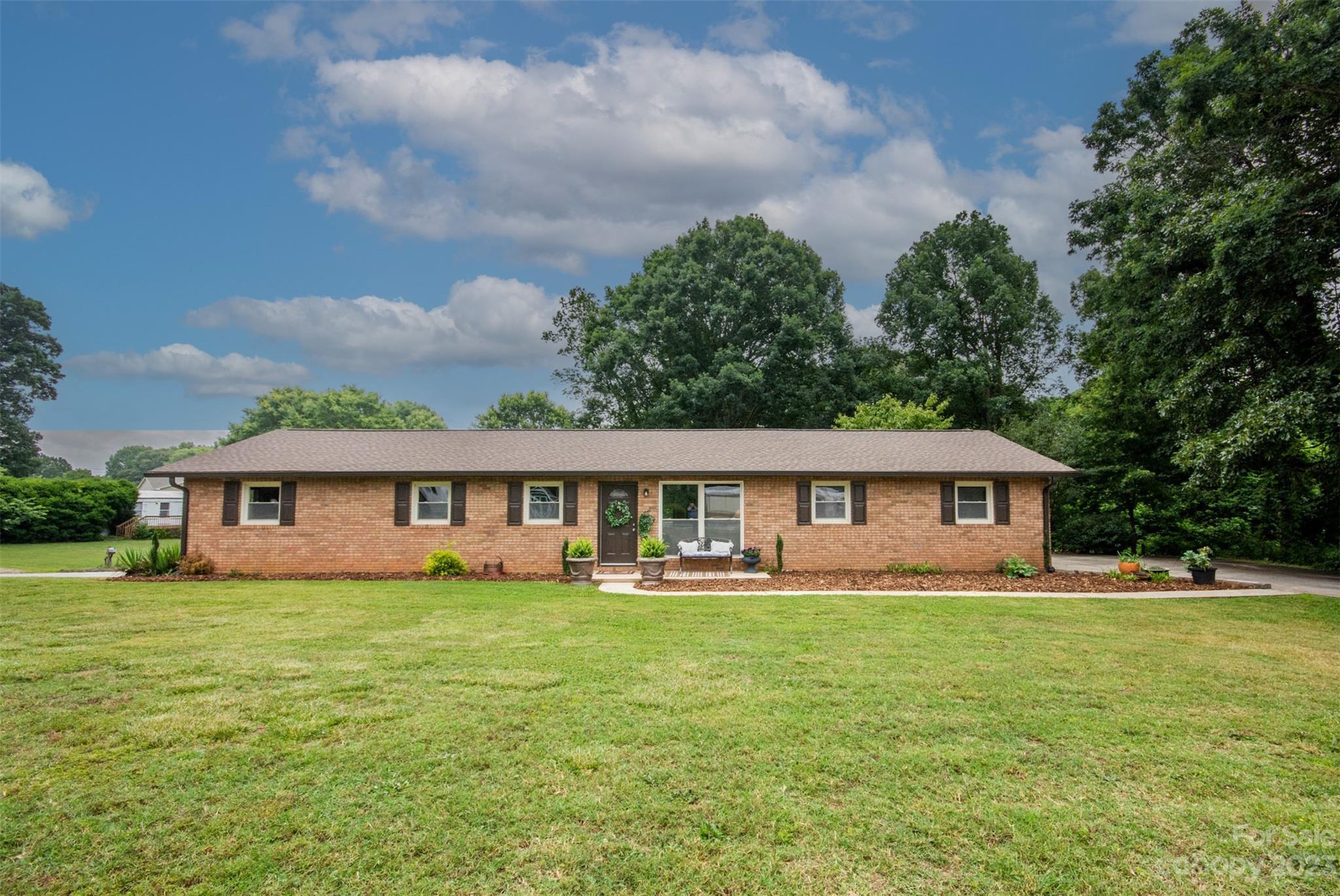357 Pop Davis Road Taylorsville, NC 28681 - Photo 2 of 45 a view of a house with a big yard and large trees