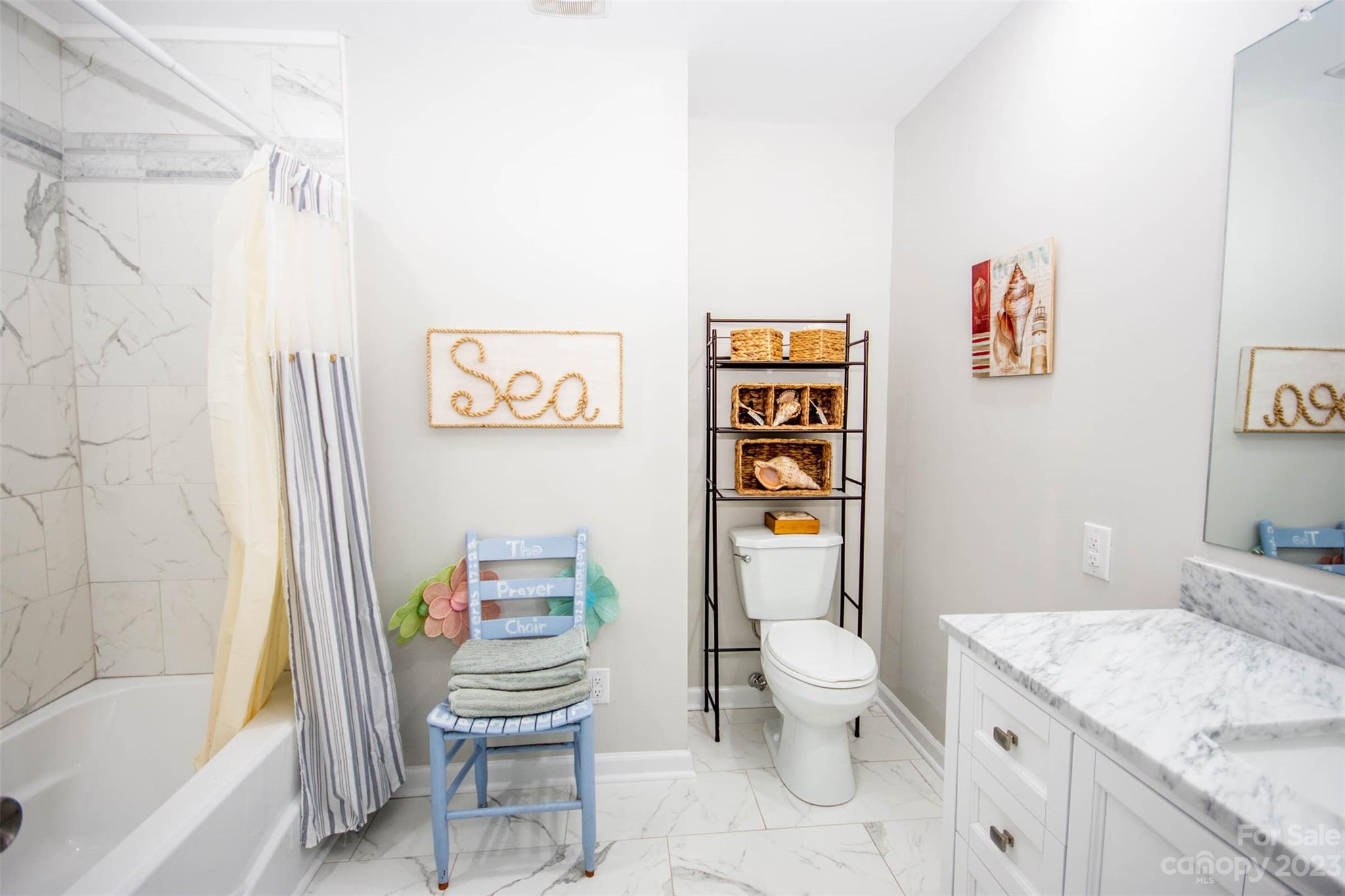 357 Pop Davis Road Taylorsville, NC 28681 - Photo 21 of 45 a bathroom with a granite countertop sink mirror vanity and toilet