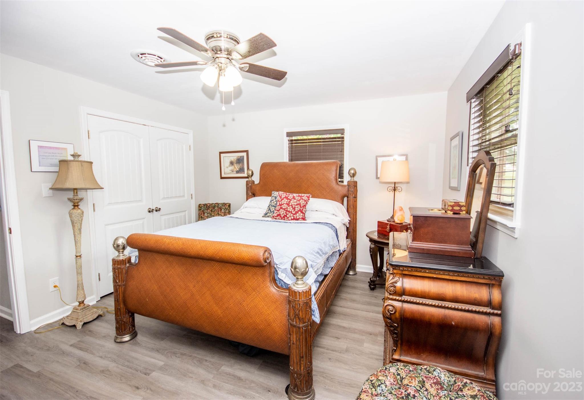 357 Pop Davis Road Taylorsville, NC 28681 - Photo 26 of 45 a bedroom with a bed and a chandelier