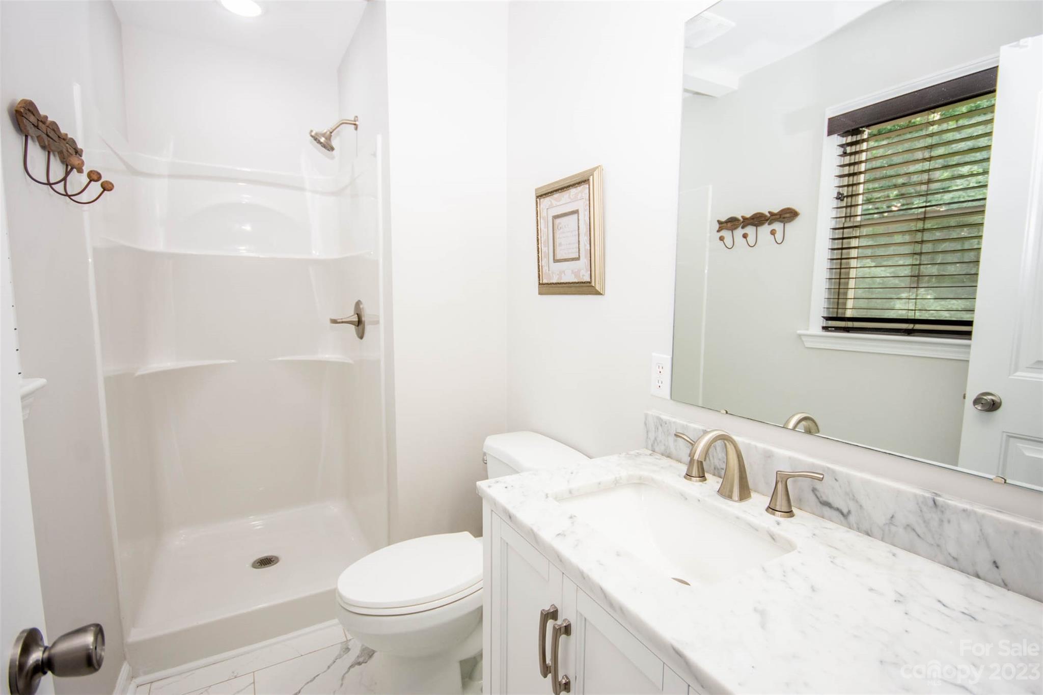 357 Pop Davis Road Taylorsville, NC 28681 - Photo 27 of 45 a bathroom with a granite countertop sink toilet and shower