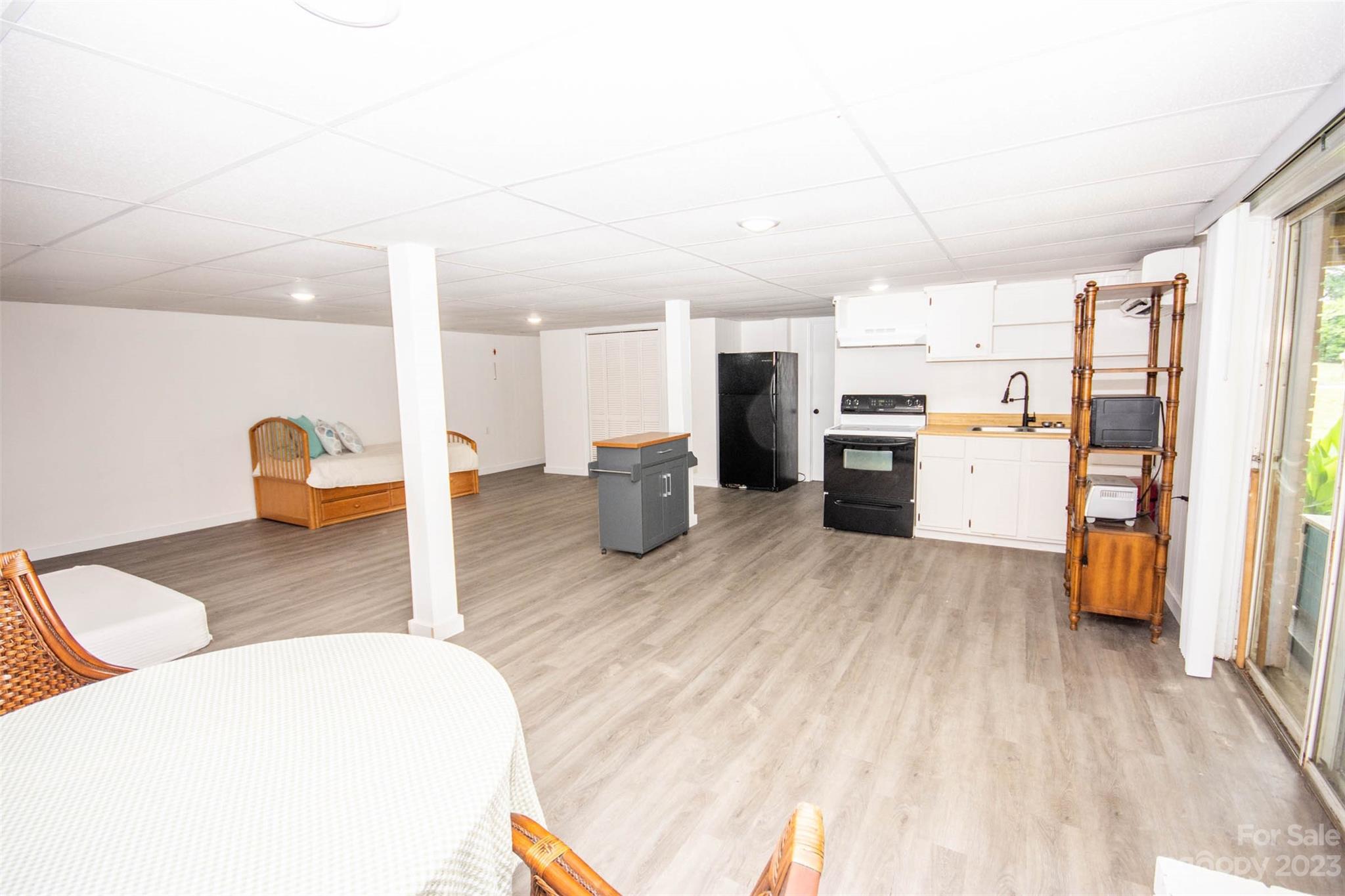 357 Pop Davis Road Taylorsville, NC 28681 - Photo 30 of 45 a large bedroom with a bed and a view of kitchen