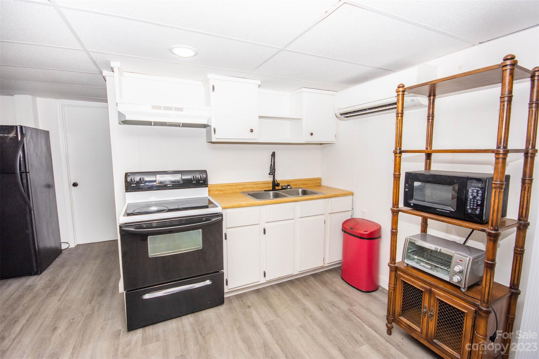 357 Pop Davis Road Taylorsville, NC 28681 - Photo 31 of 45 a kitchen with granite countertop a stove top oven microwave and cabinets